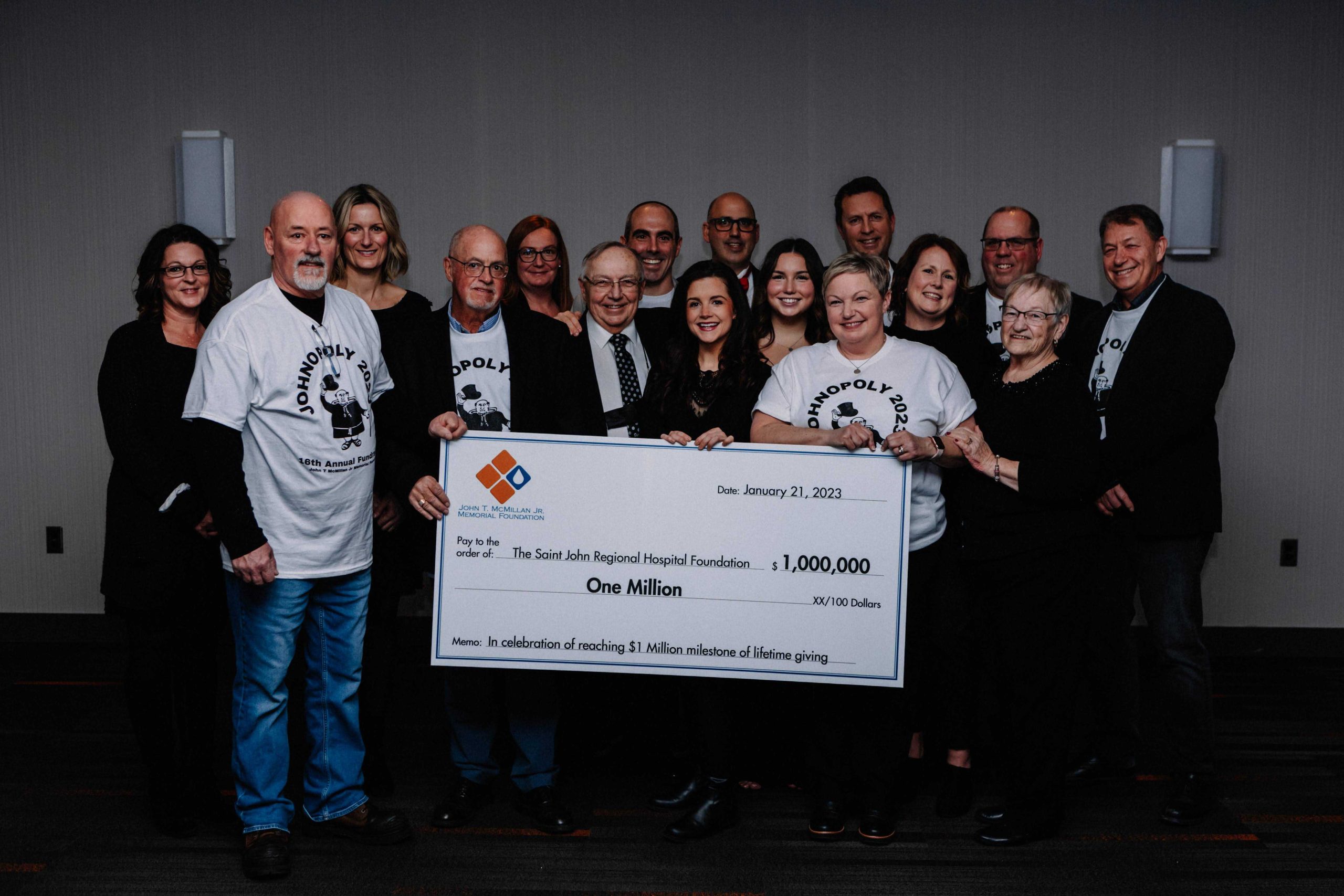 Cheque photo members of the Saint John Regional Hospital Foundation are joined by the Mc Millan family as well as members of the board past and present for the John T Mc Millan Jr Memorial Foundation.