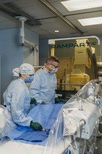Dr. Jaroslav Hubacek, Interventional Cardiologist and Kim Beveridge, scrub nurse are protected from radiation exposure while performing procedures. 