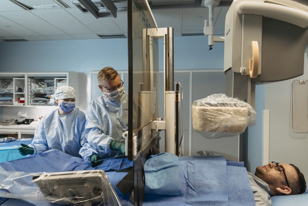 Rampart offers protection to both the physician as well as the clinicians in the room, ensuring a safer working environment. (Pictured: Kim Beveridge, scrub nurse, Dr. Jaroslav Hubacek, Interventional Cardiologist and Joshua Mackin, BN as the patient)